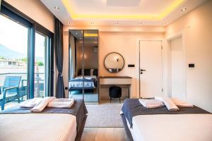 two beds in a room with a mirror at Villa Unique 2 in Fethiye +23 photos