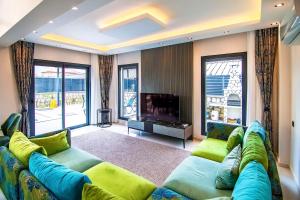 a living room with a large couch and a television at Villa Unique 2 in Fethiye