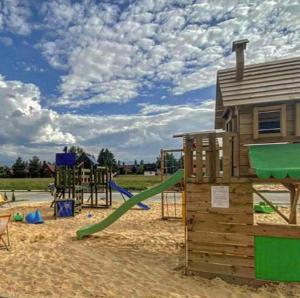 GÓRALSKIE NOWE APARTAMENTY BIAŁKA - Skibus, Sauny, Bania, Sale zabaw - w cenie في بيالكا تاترزانسكا: حديقة بها ملعب مع زلاجة