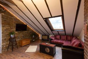 a living room with a couch and a brick wall at Haus-Elena in Bestwig