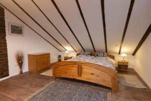 a bedroom with a wooden bed in a attic at Haus-Elena in Bestwig