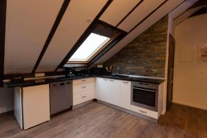 a kitchen with white cabinets and a window at Haus-Elena in Bestwig +1 photo