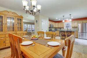 a large kitchen with a wooden table and chairs at Fire Pit, Games and Outdoor Fun! Poconos Retreat in Blakeslee