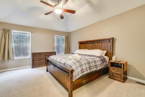 a bedroom with a bed and a ceiling fan at Fire Pit, Games and Outdoor Fun! Poconos Retreat in Blakeslee
