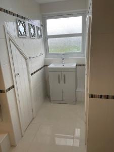 a bathroom with a sink and a window at Swn yr Coed in Sennybridge +20 photos