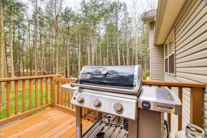 a grill on the deck of a house at Fire Pit, Games and Outdoor Fun! Poconos Retreat in Blakeslee
