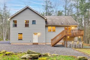 a house with a wooden deck and a house at Fire Pit, Games and Outdoor Fun! Poconos Retreat in Blakeslee
