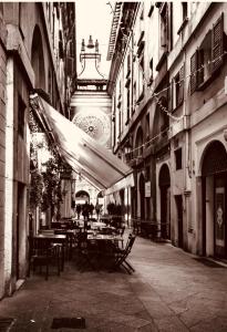 an alley with tables and chairs in a building at La Casa di Alissia a Brescia in Brescia