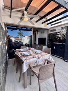 a table with chairs and a tablecloth on a patio at Maspalomas Lago 36 in Maspalomas