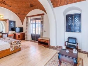 a bedroom with a bed and a table and a chair at Beach safari suites &expedition in Marsa Alam City