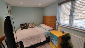 a small bedroom with two beds and a window at Quiet Loft Double Room forty-five minutes by train to London Liv Street in Braintree