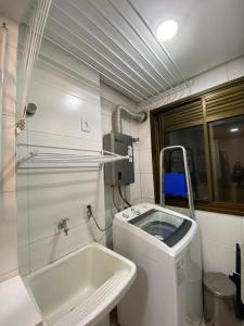 a small bathroom with a sink and a toilet at Apartment in bairro Fazenda, Itajaí, 2 bedrooms with ocean view in Itajaí