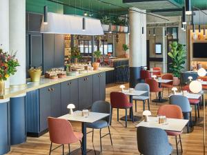a restaurant with tables and chairs and a bar at Novotel Paris Gare De Lyon in Paris