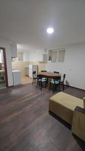 a room with a table and chairs and a kitchen at Čiča 1 in Dobanovci