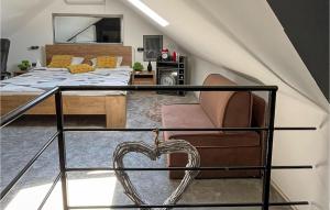 a bedroom with a bed and a chair with a heart at Gorgeous Home In Slavonski Brod With Sauna in Podvinje