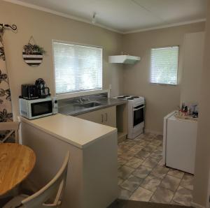 a kitchen with a sink and a stove top oven at Hydrangea Cottage in Marton in Marton