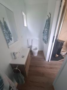 a white bathroom with a toilet and a sink at Little Hurst House - Escape the Ordinary in Inglewood +13 photos