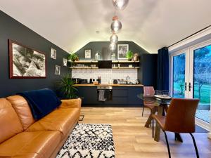 a living room with a couch and a table at The Annexe in Yeovil Junction