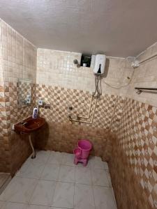 a bathroom with a sink and a toilet and a phone at AP Homestay in Faizābād +36 photos