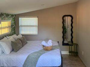 a bedroom with a bed with a basket on it at 20 Off The Jungle House 10 min Beach & FLL Airport in Fort Lauderdale