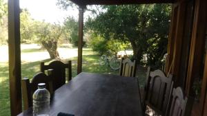 a table with a water bottle sitting on top of it at La casita del bosque in Punta Indio