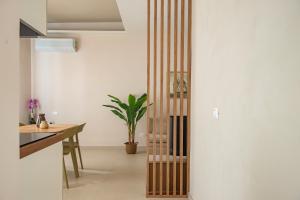 a pivot door in a kitchen with a plant at Marina Suite Elba in Marina di Campo