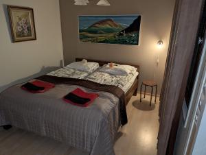 a bedroom with a bed with two towels on it at Arctic Red House in Rovaniemi