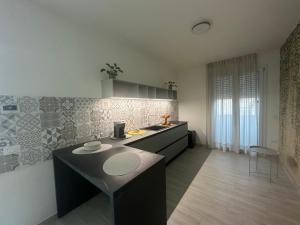 a kitchen with a sink and a counter top at The Rooms Catanzaro Lido in Catanzaro Lido