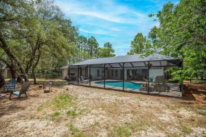 a house with a swimming pool and a tent at Citrus Springs Oasis-Rainbow River, Manatees, Golf in Citrus Springs