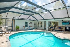 a large swimming pool with a large glass roof at Citrus Springs Oasis-Rainbow River, Manatees, Golf in Citrus Springs