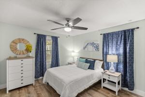 a bedroom with a bed and a ceiling fan at Citrus Springs Oasis-Rainbow River, Manatees, Golf in Citrus Springs +57 photos