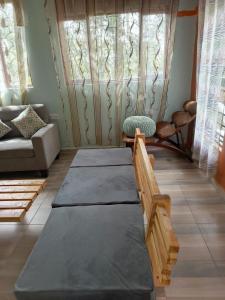 a living room with a couch and a table at Kio Farm Retreat 2 in Kiserian +2 photos