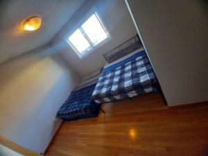 an attic bedroom with a bed with a window at Central Location New Year Stay- Free Parking & Fast Wifi in Kitchener