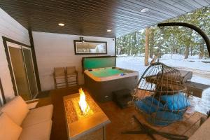 a room with a pool table and a fire in it at Brand New Cabin with Fire Pit & Outdoor Projector in Duck Creek Village