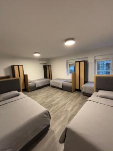 a room with three beds and a couch at Hostel P16 in Zagreb +36 photos