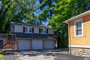 a house with two garage doors next to a house at FIFA 2026 Hub - Philadelphia Area in Bryn Mawr