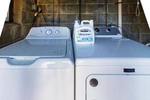 a bottle of milk sitting on top of a washer and dryer at FIFA 2026 Hub - Philadelphia Area in Bryn Mawr