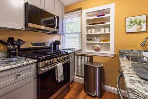 a kitchen with a stove and a microwave at FIFA 2026 Hub - Philadelphia Area in Bryn Mawr +9 photos