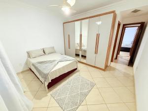 a bedroom with a bed and a sliding glass door at Sossego Ponta da Fruta in Vila Velha +19 photos