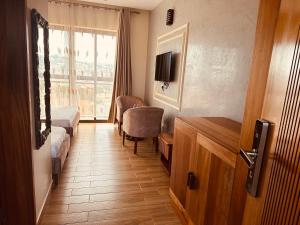 a hotel room with a bed and a window at Flamarc Hotel in Kampala