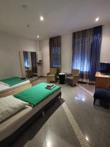 a large room with two beds and chairs in it at Ferienwohnung-Monteurwohnung-Parkplatz in Meine