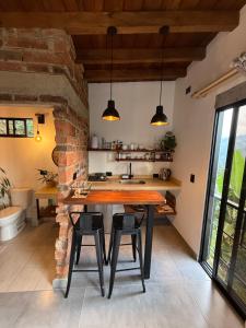 a kitchen with a large wooden table and chairs at Montecafé Jardín in Jardin