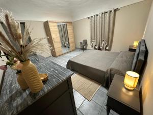a bedroom with a bed and a table with a vase at Verde Speranza Apartment in Crescentino