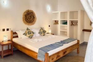 a bedroom with a large bed in a room at Shirley Boutique Hotel in Kiwengwa