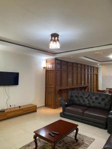 a living room with a couch and a coffee table at Eddie Homes Rwanda in Kigali