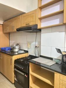 a kitchen with a black stove top oven at Eddie Homes Rwanda in Kigali
