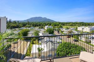 a balcony with a view of a parking lot at Cozy 2BD Condo, Near Beach in San Felipe de Puerto Plata