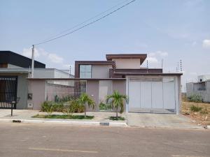 a house with a fence and palm trees in front of it at House snp in Sinop