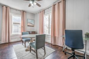 a dining room with a table and chairs and windows at The Clearview Hideaway - Cozy in Memphis +15 photos