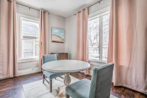 a dining room with a table and chairs and windows at The Clearview Hideaway - Cozy in Memphis